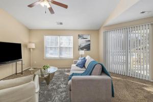 a living room with a couch and a flat screen tv at Landing - Modern Apartment with Amazing Amenities (ID8457) in Peerless Park