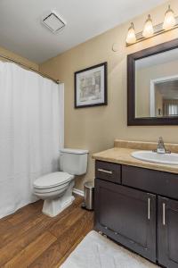 a bathroom with a toilet and a sink and a mirror at Landing - Modern Apartment with Amazing Amenities (ID8457) in Peerless Park