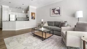 a living room with a couch and a table at Landing - Modern Apartment with Amazing Amenities (ID1374X809) in Charlotte