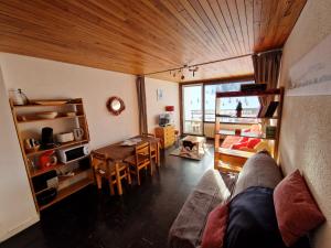 a living room with a couch and a table at Résidence LES CHAMOIS Pied des pistes Chamrousse in Chamrousse