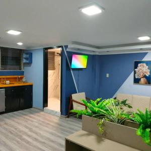 a living room with a blue wall with a rainbow at Stylish studio apartment in Quito