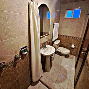 a bathroom with a sink and a toilet and a shower at Hotel Confort Plaza in Culiacán