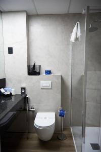 a bathroom with a toilet and a shower at Hotel Concorde in Arona