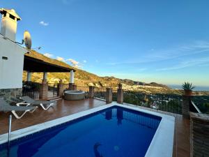 a villa with a swimming pool with a view at Villa en Frigiliana con piscina, jacuzzi y espectaculares vistas in Frigiliana