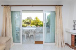 a living room with a table and chairs at Spacious 3BR in Miraflores near all amenities in Málaga