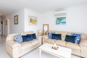 a living room with two couches and a coffee table at Spacious 3BR in Miraflores near all amenities in Málaga
