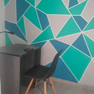 a desk and a chair next to a wall at Perfect Suite, near everything! ¡cerca de todo! in Quito