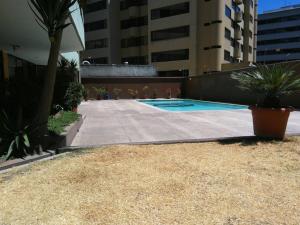 a swimming pool in the middle of a building at Perfect Suite, near everything! ¡cerca de todo! in Quito