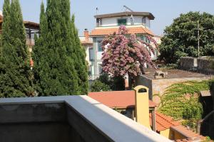 a view of a building from a balcony with trees at Flat House in Fiumicino