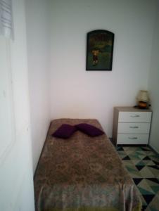 a small bedroom with a bed and a dresser at Ivone guest in Maisons-Alfort