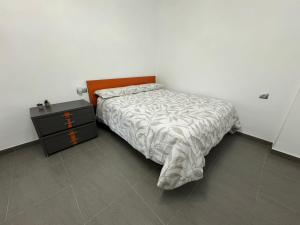 a small bedroom with a bed and a nightstand at Apartamento Novo en Montealegre amplio y comodo in Montealegre del Castillo