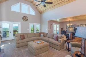 a living room with a couch and a table at Almost Bearadise Brand New 5 Bedroom Home with Views in Black Mountain