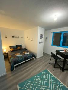 a bedroom with a bed and a table and a desk at Strasbourg Lifestyle in Strasbourg