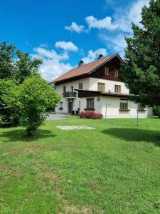 a large white house with a green yard at Landhaus Nikki in Gmünd in Kärnten