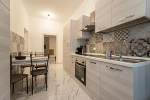 a kitchen with a sink and a table with chairs at TERMINI HOLIDAY in Rome +15 photos