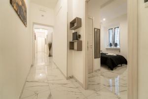 a white hallway with a bed in a room at TERMINI HOLIDAY in Rome