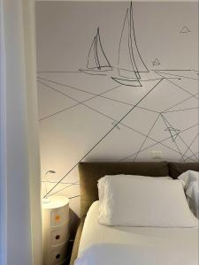 a bedroom with a wall mural of sailboats at Garni Hotello Sport And Relax in Riva del Garda