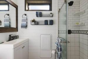 a bathroom with a shower and a toilet and a sink at The Blue Ridge "Romantic" Tiny Home Near Magnolia & Baylor in Bellmead