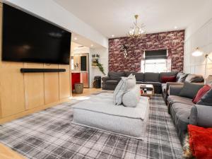 a living room with a couch and a flat screen tv at The Red Well Country Inn in Carnforth