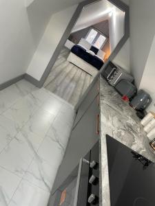 an overhead view of a living room with white marble floors at Modern apartment next to airport in Marston Green