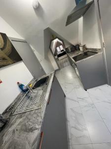 a kitchen with a sink and a counter top at Modern apartment next to airport in Marston Green