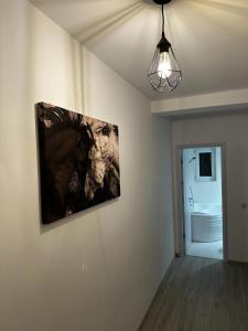 a painting hanging on a wall in a room at Best Apartment Suceava in Suceava +45 photos