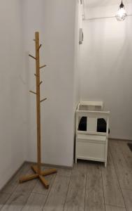 a room with a tree and a white wall at Best Apartment Suceava in Suceava