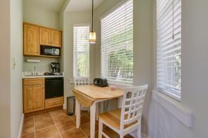 a small kitchen with a wooden table and chairs at Riverfront Florida Studio with Pool and Hot Tub Access in La Belle