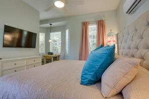 a bedroom with a large bed with blue pillows at Riverfront Florida Studio with Pool and Hot Tub Access in La Belle