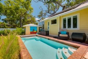 a swimming pool in front of a house at Riverfront Florida Studio with Pool and Hot Tub Access in La Belle
