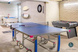 a ping pong table in a room with a ping pong table at Comfort Hill - Luxury hot tub views games room in Overcombe