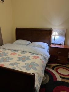 a bedroom with a bed and a table with a lamp at Comfortable room in Riverside in Riverside