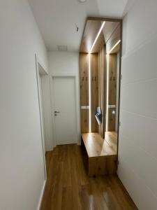a room with a hallway with a door and wooden floors at Mona Luxury Apartments - Free Garage Parking in Sarajevo
