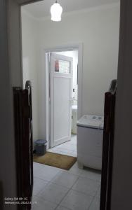a bathroom with a door leading into a bathroom with a tub at Kerlos house in 6th Of October