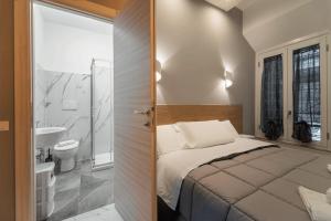 a small bedroom with a bed and a bathroom at TERMINI HOLIDAY in Rome
