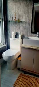 a bathroom with a white toilet and a sink at Central Winchester Serviced Apartments in Winchester