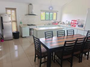 a kitchen with a table and chairs and a refrigerator at Large 4 bedroom villa with Pool in Sonaisali Nadi in Nadi