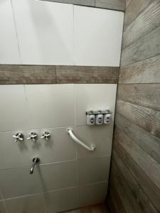 a bathroom with a shower with silver faucets at Lofturbano in Mendoza