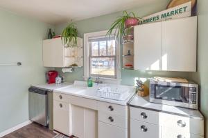 a kitchen with white cabinets and a microwave at Billings Vacation Rental about 1 Mi to Downtown! in Billings