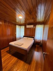 a small bedroom with a bed in a boat at Sunset View-Villa in Pacific Harbour