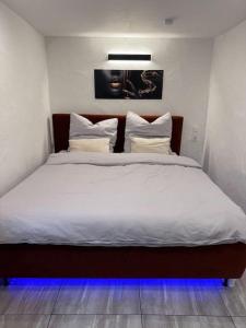 a bedroom with a large bed with white sheets and pillows at Royal Stay in Olsberg +10 photos