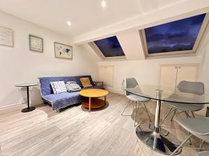 a living room with a couch and a table at Central Morden, Westfield, close to Tube station in London