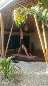 a woman doing a yoga pose on a yoga mat at Intoy's Place in Panglao