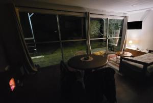 Habitación con mesa y ventana grande. en Casa Florida en Villa Serrana