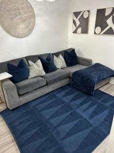a living room with a couch with blue pillows at Hertford HOME in Hertford