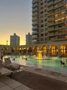 a swimming pool with a fountain in a building at Imperialeluxuryapartment in Punta del Este