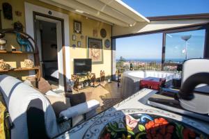a living room with a view of the ocean at Villa Gusmano in Piedimonte Etneo