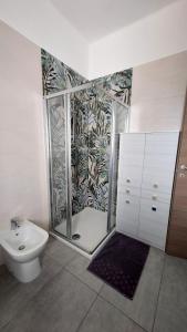 a bathroom with a shower and a toilet at Sesto Piano Apartment in Asti +23 photos