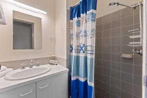 a bathroom with a sink and a shower at Alpine Mountain View 18 - 4BR l Mountain Views l Swimming Pool l Air-Con l WiFi in Jindabyne +12 photos