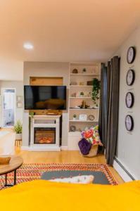 een woonkamer met een televisie en een open haard bij New Beautiful Condo In Bayonne near NYC. in Bayonne